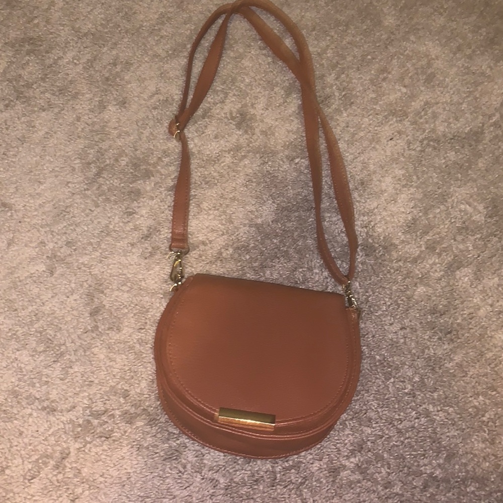 Brown shoulder bag, adjustable strap, removable strap, and leather material.
